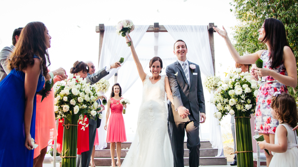 Elegant outdoor wedding, bride and groom walking down the aisle