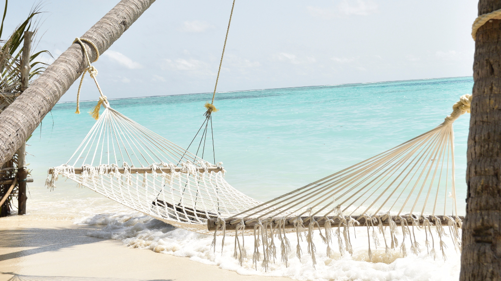 White polyester handwoven hammock by the beach